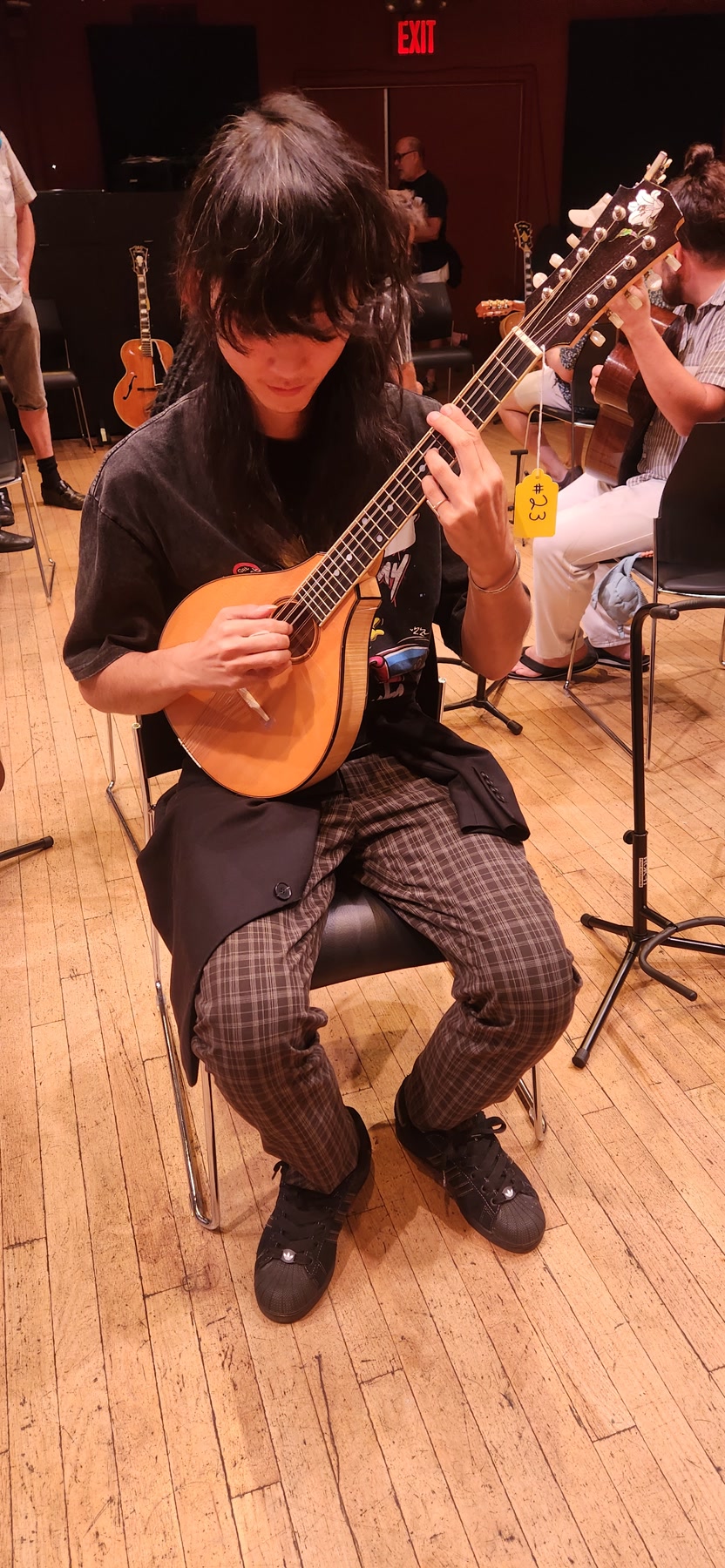 A Brooklyn Guitar Feast III attendee playing a small ten-string instrument.