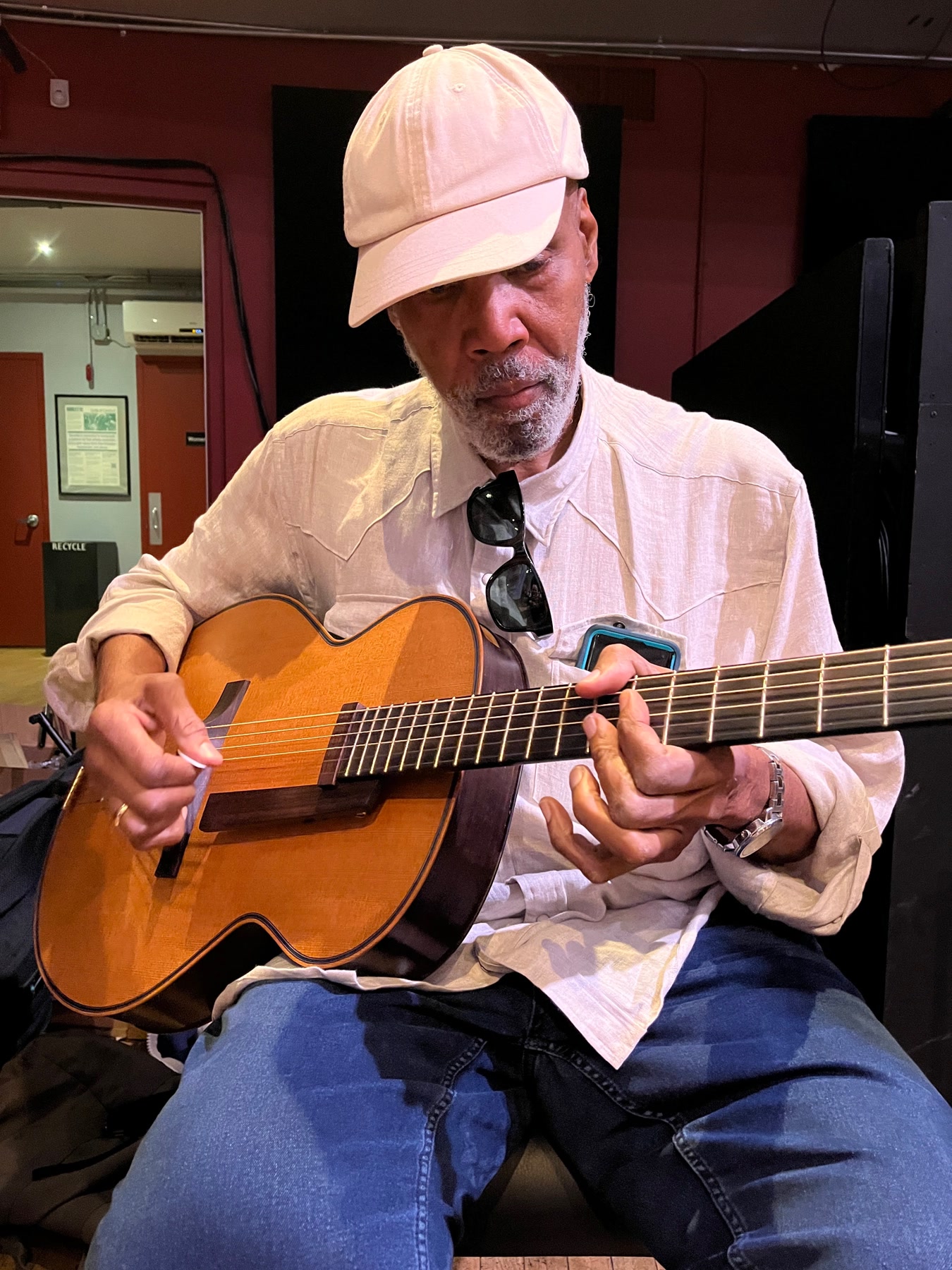 An attendee in a white cap playing an archtop guitar at Brooklyn Guitar Feast III.