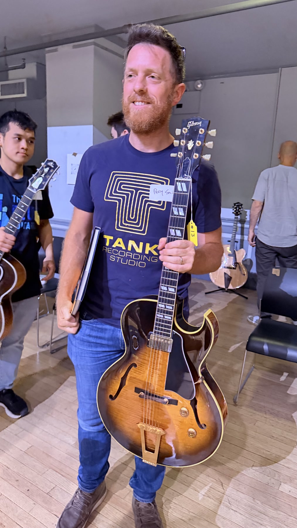 A Brooklyn Guitar Feast III attendee holding a vintage archtop guitar.