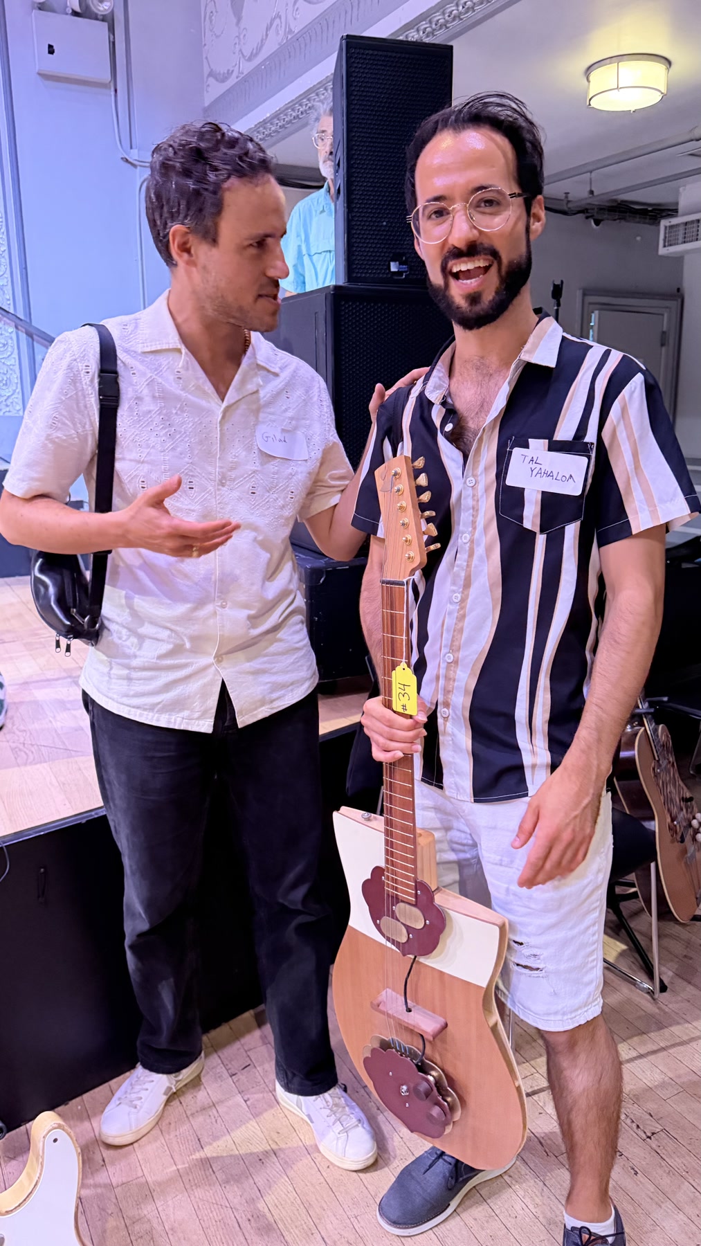 Two Brooklyn Guitar Feast III attendees with a handmade electric guitar.